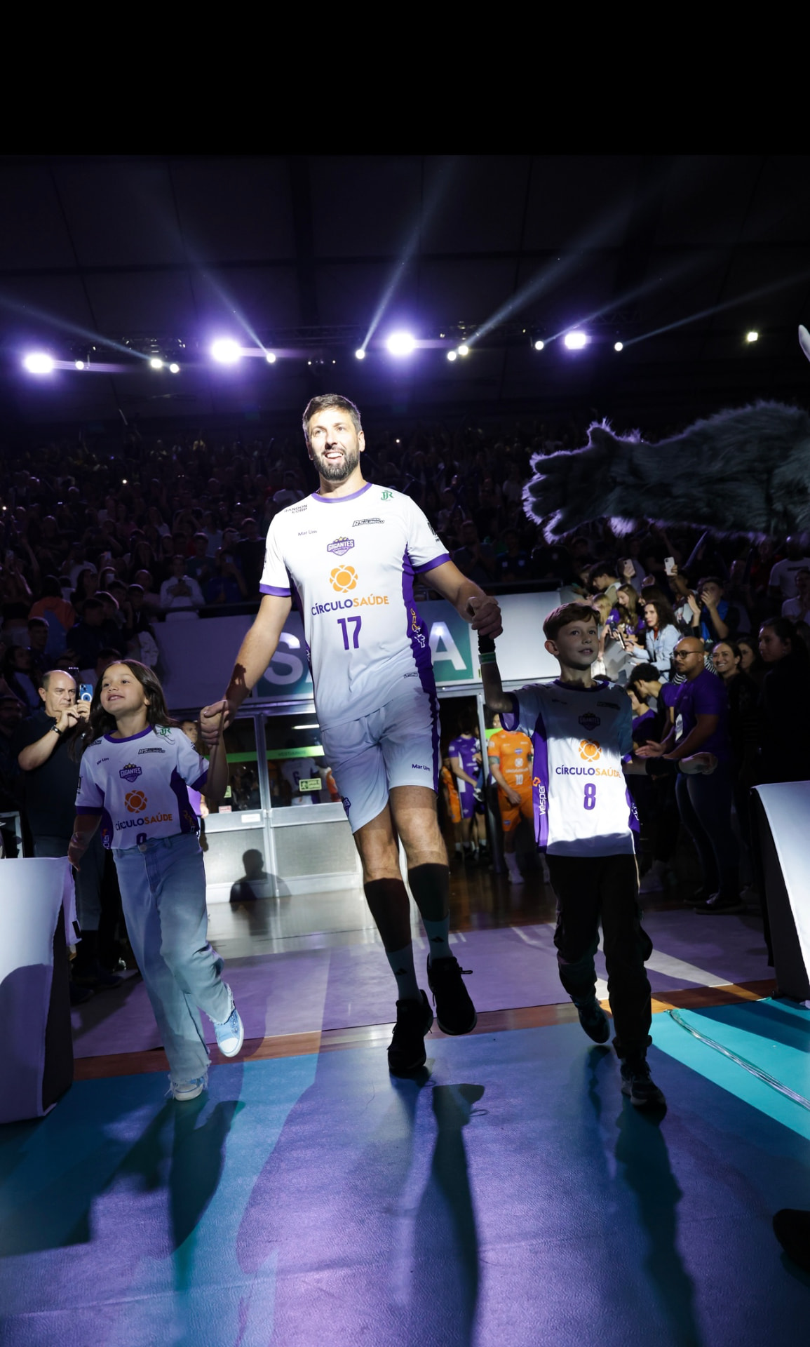 Gustavo Bonatto entering a sold-out arena with young players